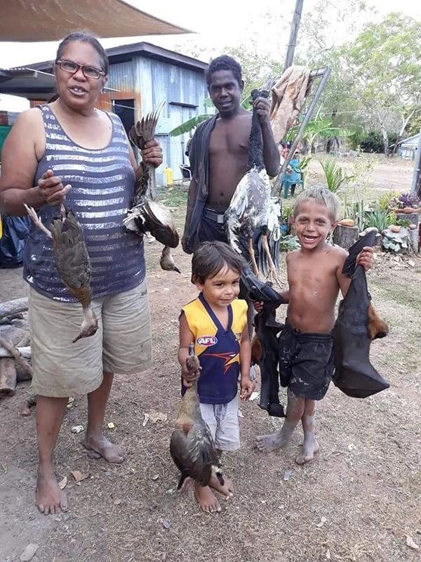 People Holding up Their Caught Animals Outdoors — Kakadu Billabong Safari Camp in Kakadu, NT