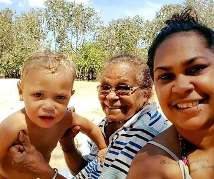 A Child, Elder, and Adult Smiling Outdoors — Kakadu Billabong Safari Camp in Kakadu, NT