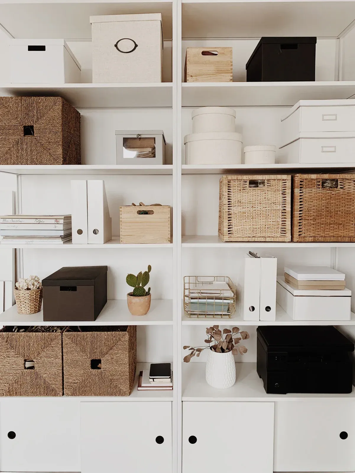 A shelf filled with lots of boxes and baskets.