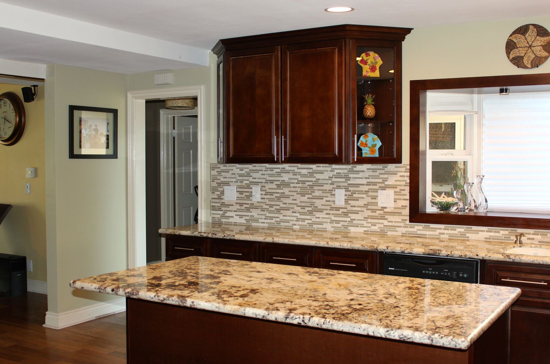 Kitchen with dark cabinets, light countertops, and a centered island.