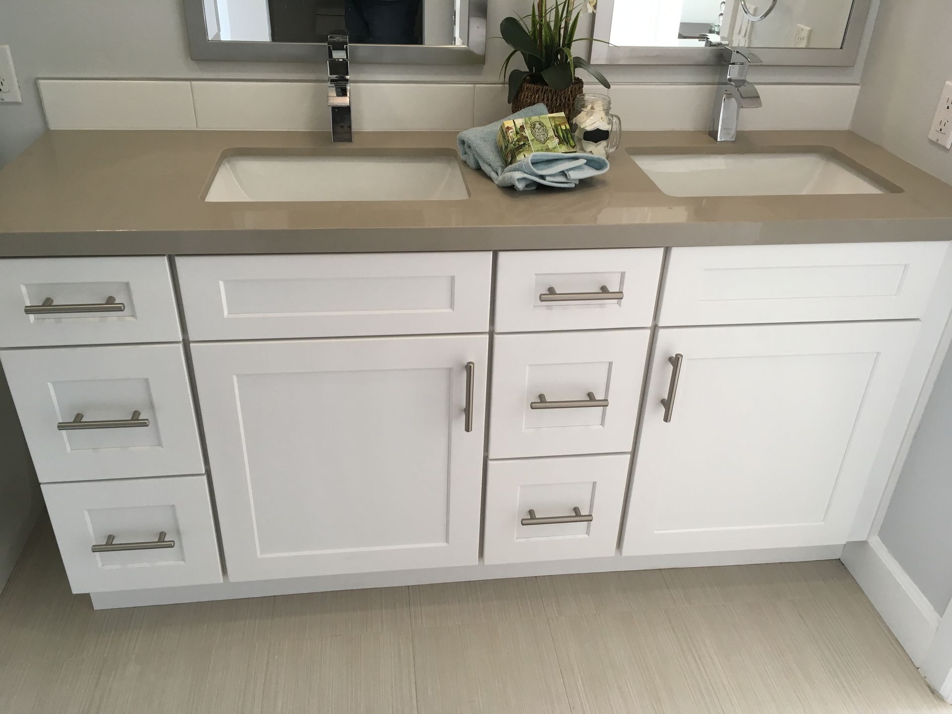 White double sink bathroom vanity with light gray countertop and silver hardware.
