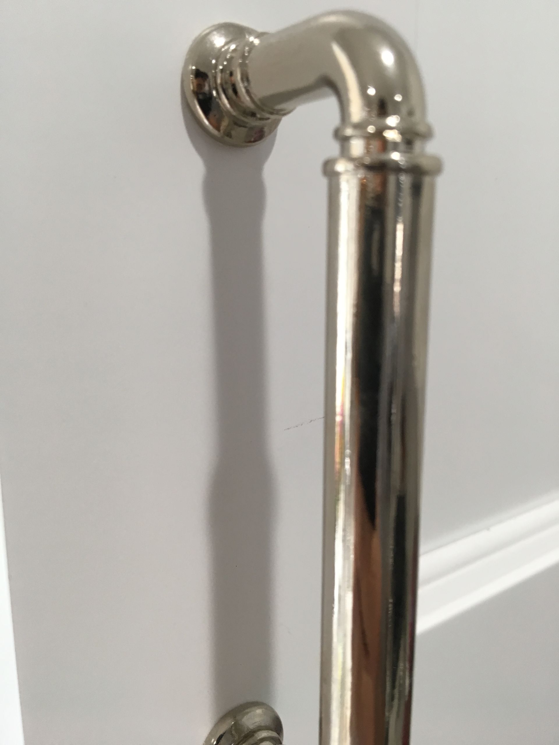 Nickel-finished door handle on a white door.