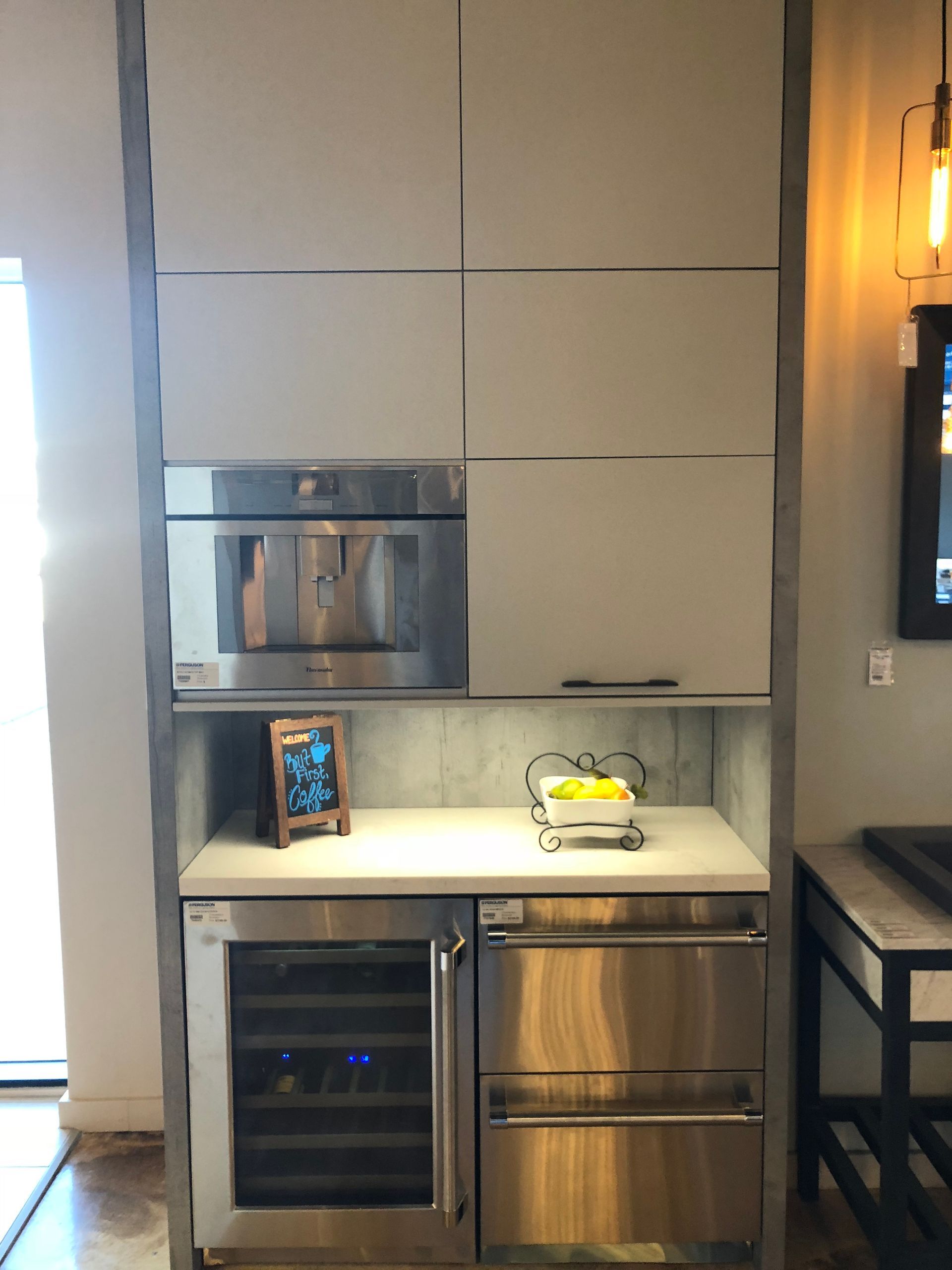 Built-in kitchen cabinet with coffee machine, wine cooler, drawers, and a small countertop.