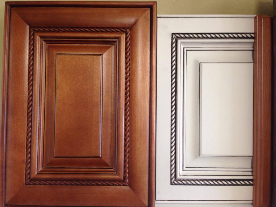 A brown cabinet door next to a white cabinet door