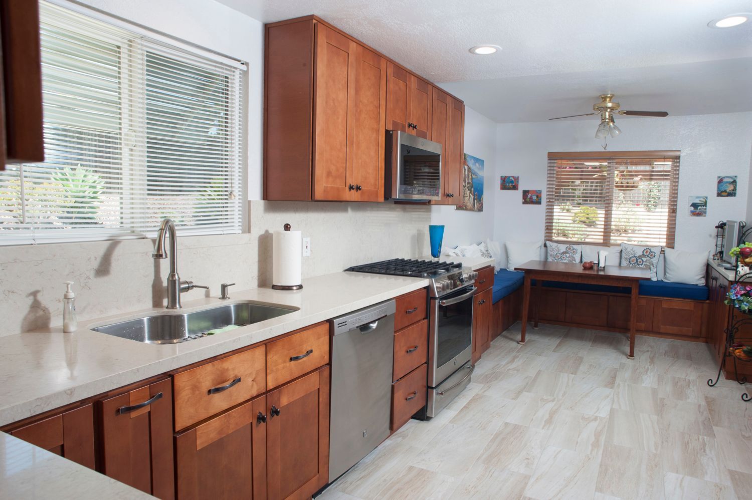 Kitchen with wood cabinets, stainless steel appliances, and a small dining area.