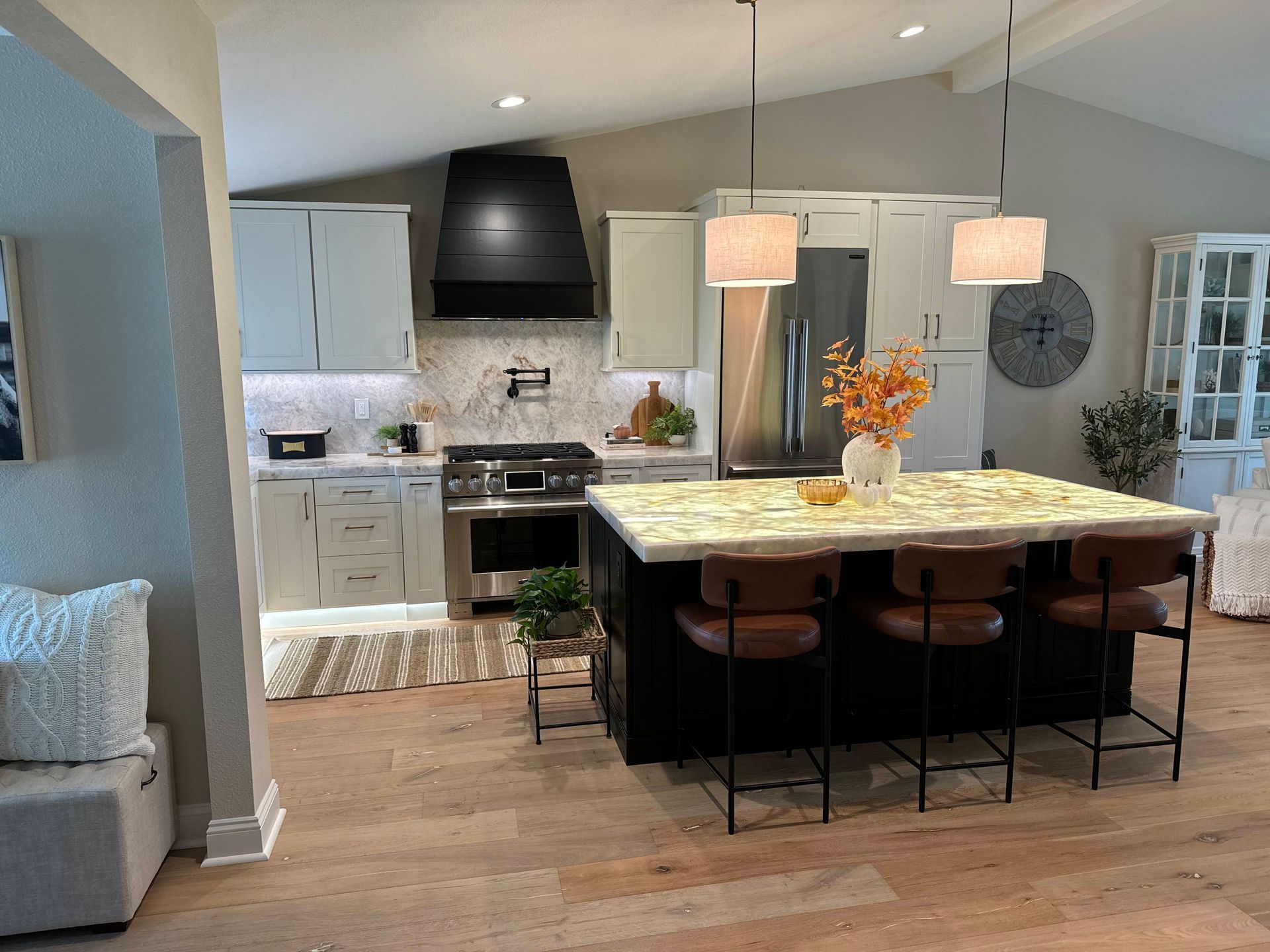 Modern kitchen with island, range, and cabinets in neutral tones.