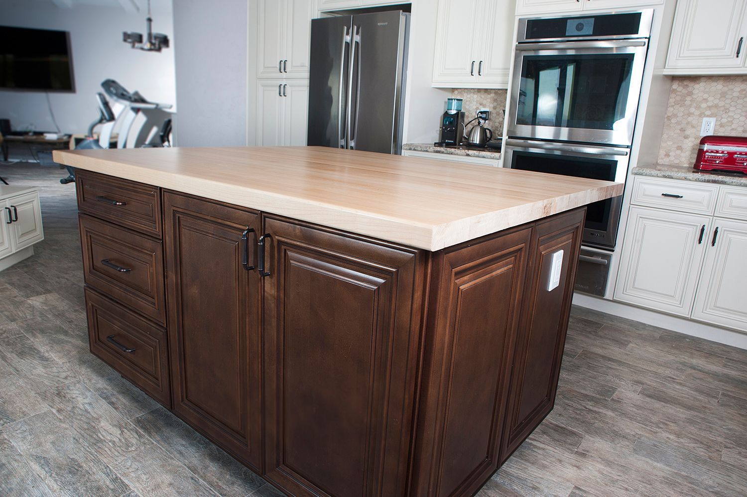 Kitchen island with a brown wooden cabinet and tan countertop.