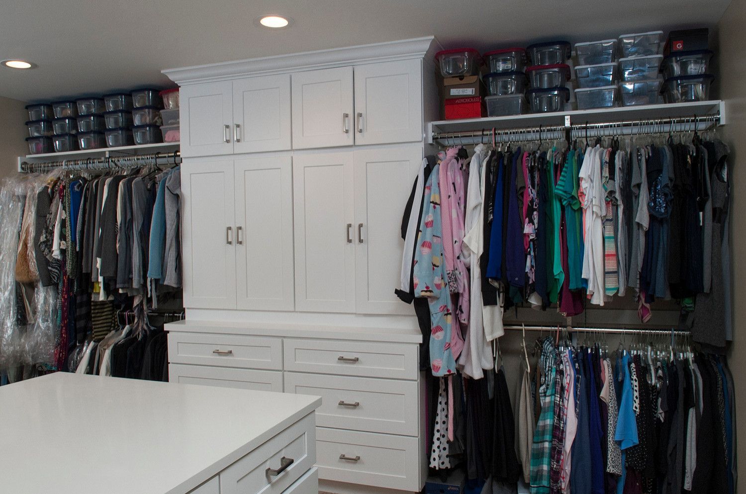 A closet filled with lots of clothes and drawers.