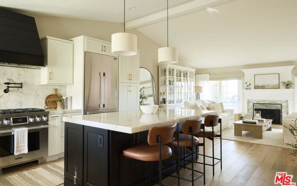 A bathroom with two sinks , a mirror and a rug.