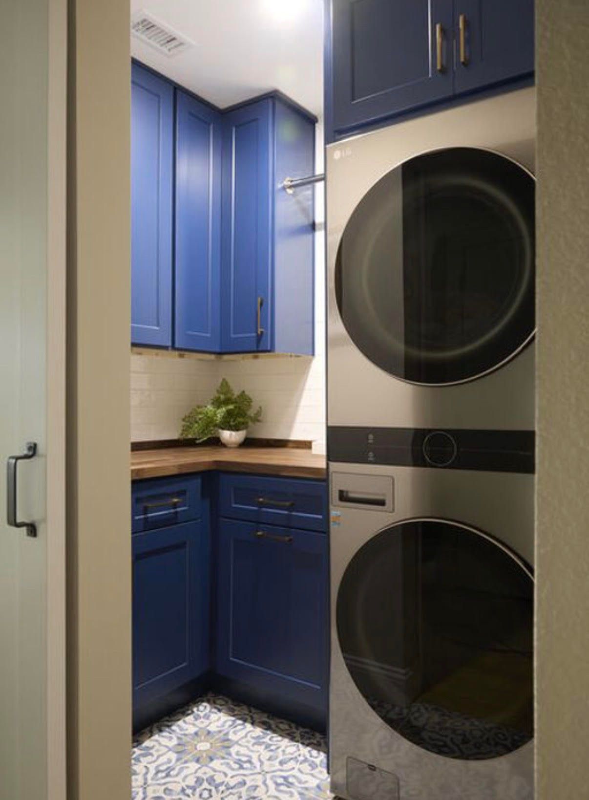 A washer and dryer are stacked on top of each other in a laundry room.