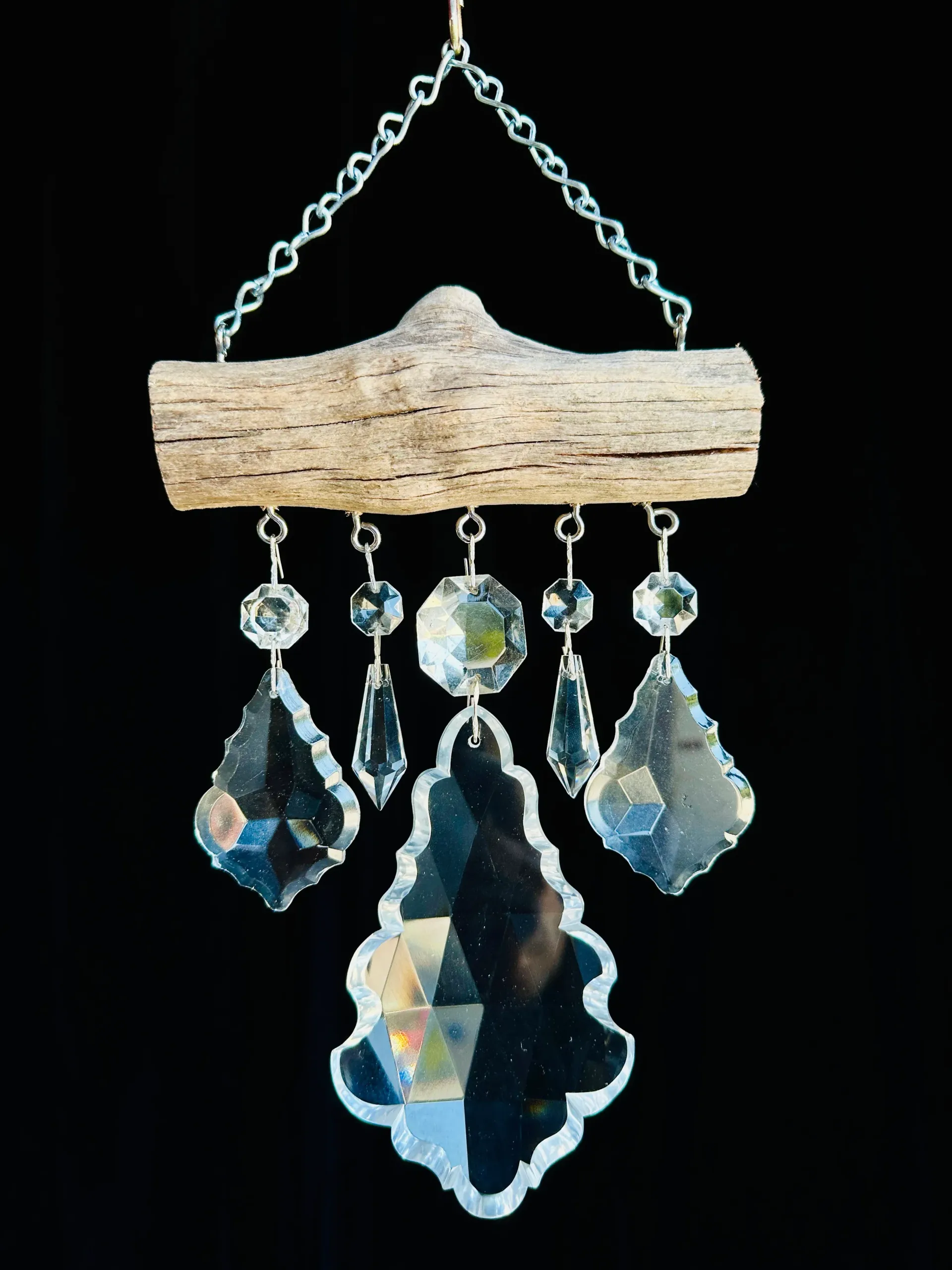 A piece of wood with crystals hanging from it
