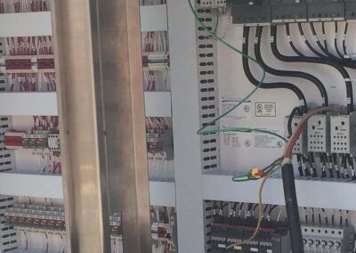 Electrical control panel with wiring, terminals, and circuit components inside an industrial cabinet