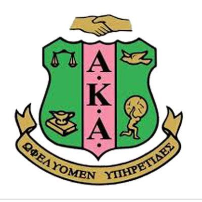 Green and pink academic crest with scales, torch, book, handshake, and Greek lettering around it