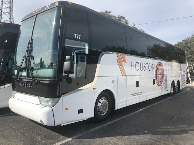 a houston bus is parked in a parking lot