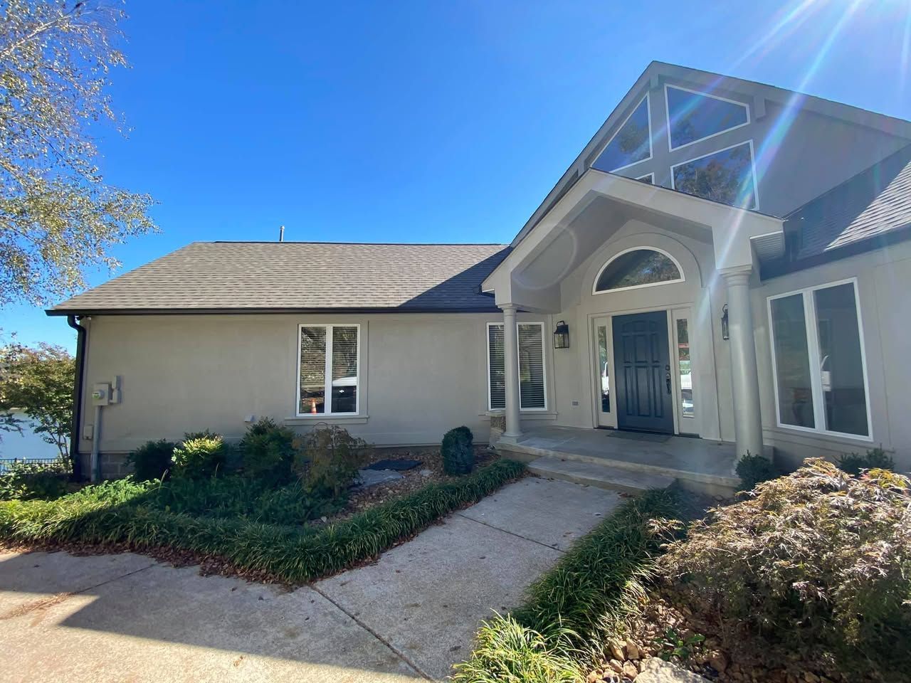 A large house with a lot of windows and a walkway leading to it.