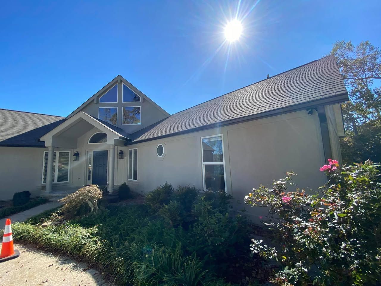 A large house with a roof that has a cross on it and a lot of windows.