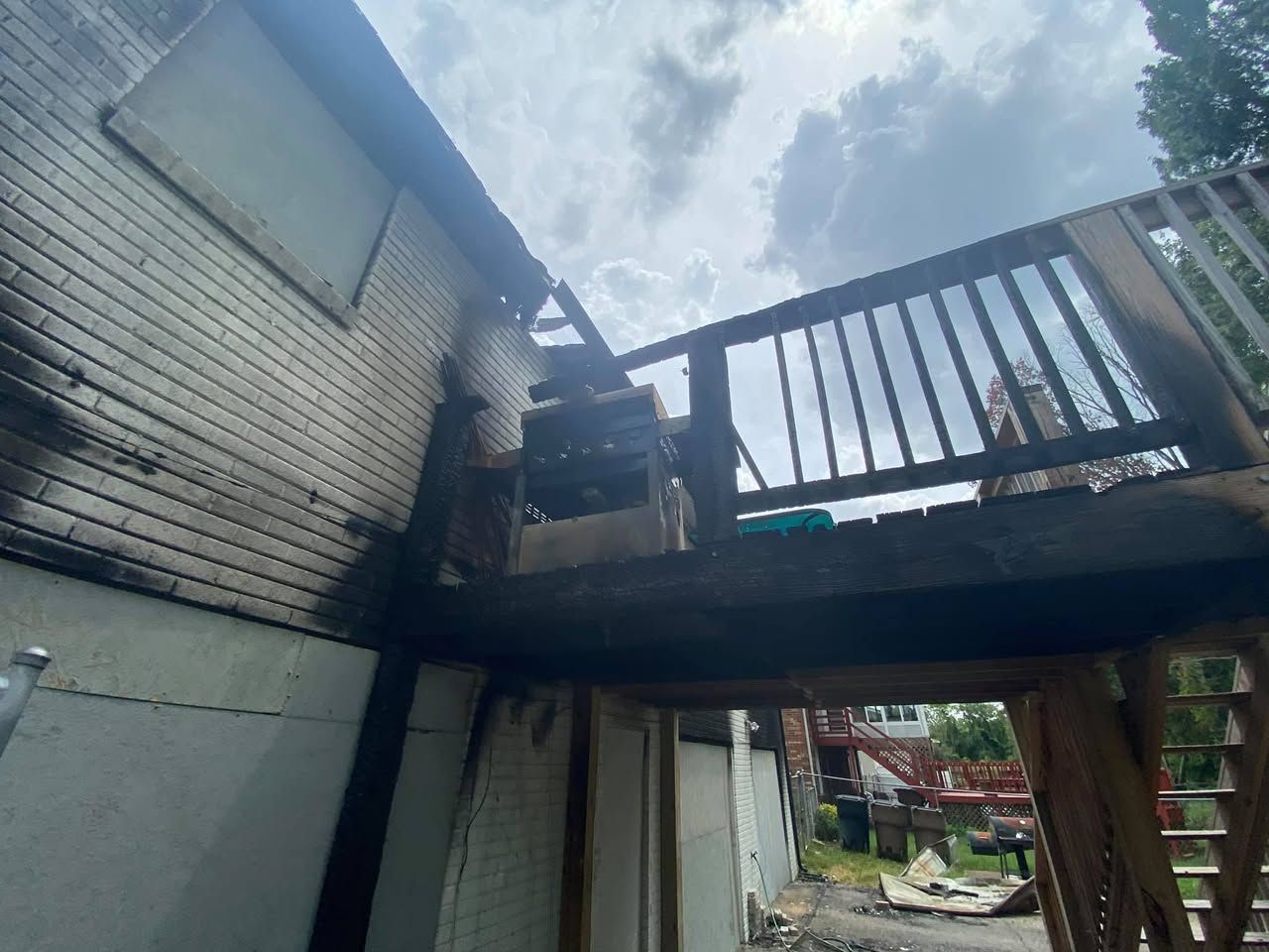 A house with a deck that has been damaged by a fire.