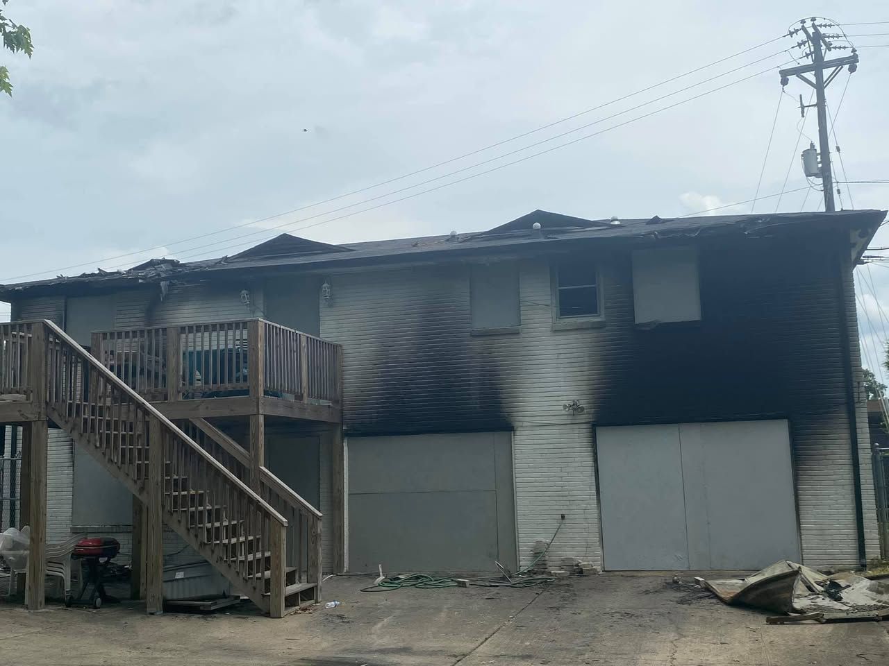 A house that has been damaged by a fire with stairs leading up to it.