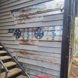 There is a staircase leading up to the side of a building.