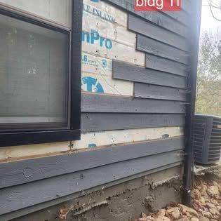 The side of a house with a window and an air conditioner.