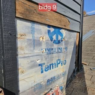 A piece of styrofoam is sitting on the side of a building.