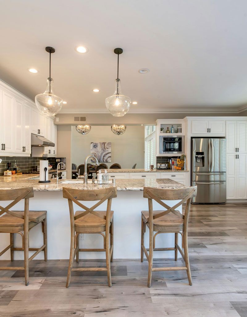 A kitchen with a large island and stools