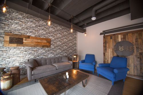 A living room with a couch , chairs and a coffee table