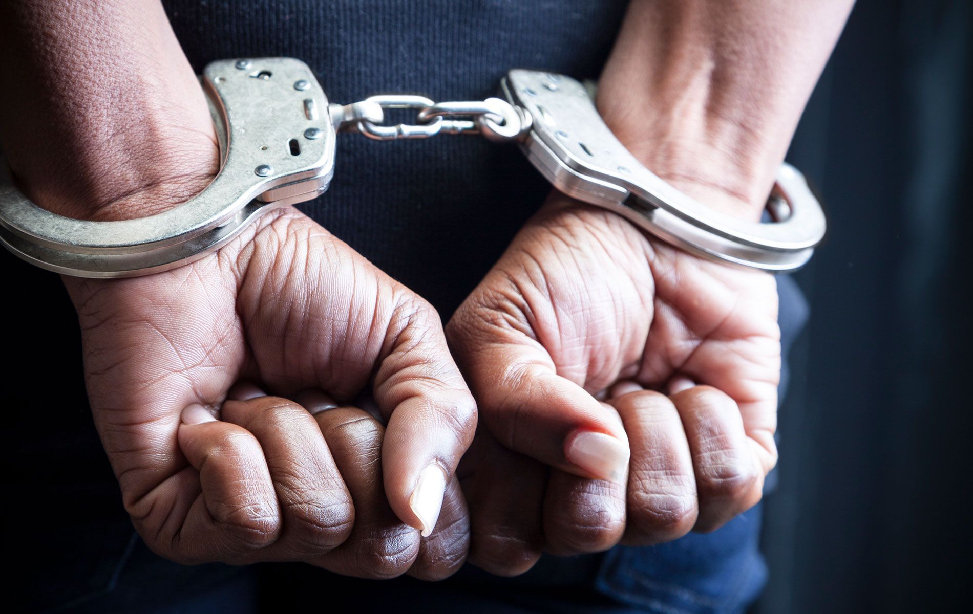 A hand of a man with a handcuff