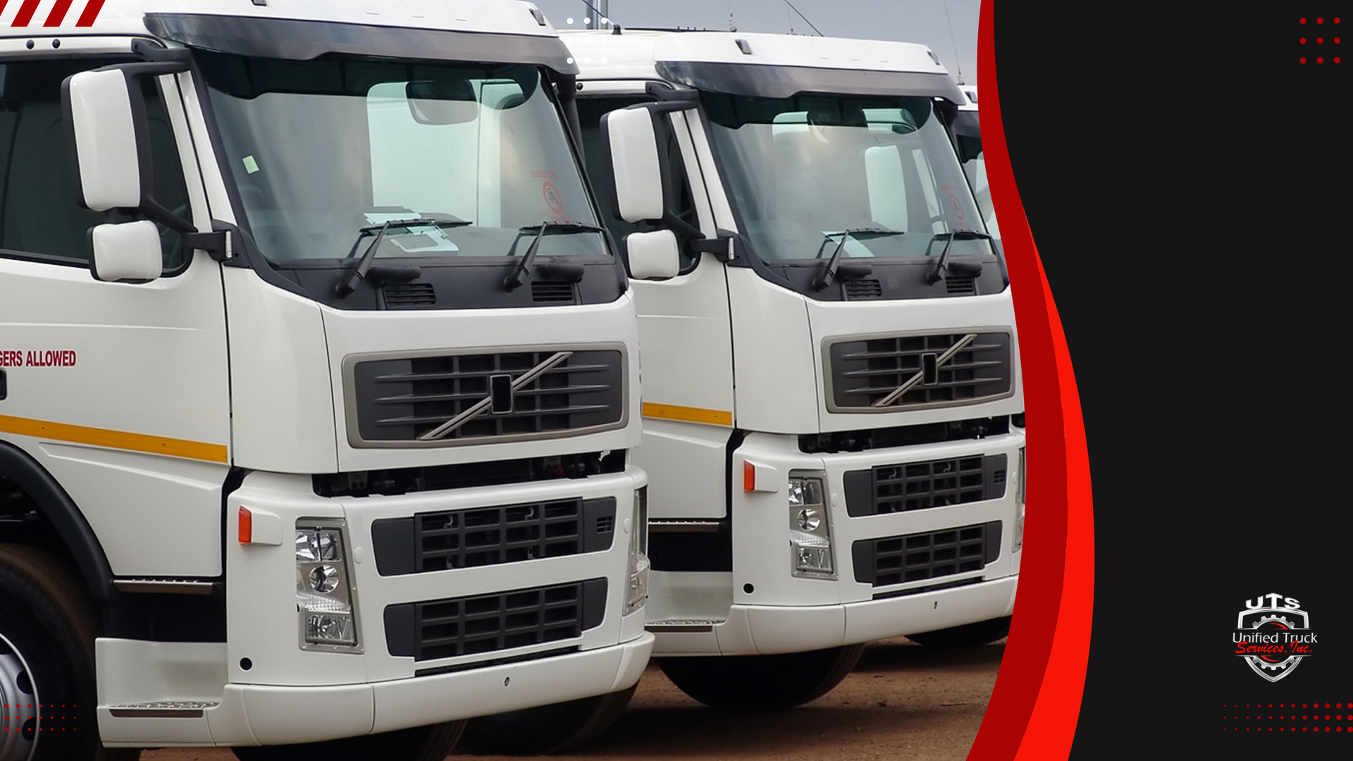 Two white volvo trucks are parked next to each other in a parking lot.