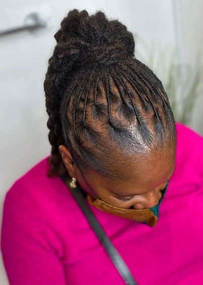 black dreadlocks tied back in ponytail