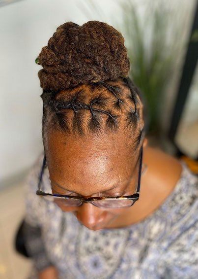 brown dreadlocks in bun on top of head