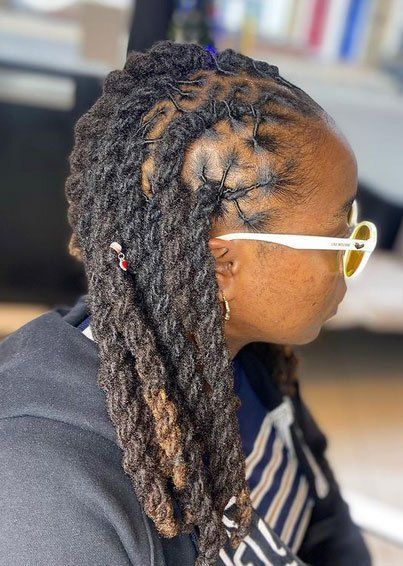 woman wearing sunglasses with long black dreadlocks