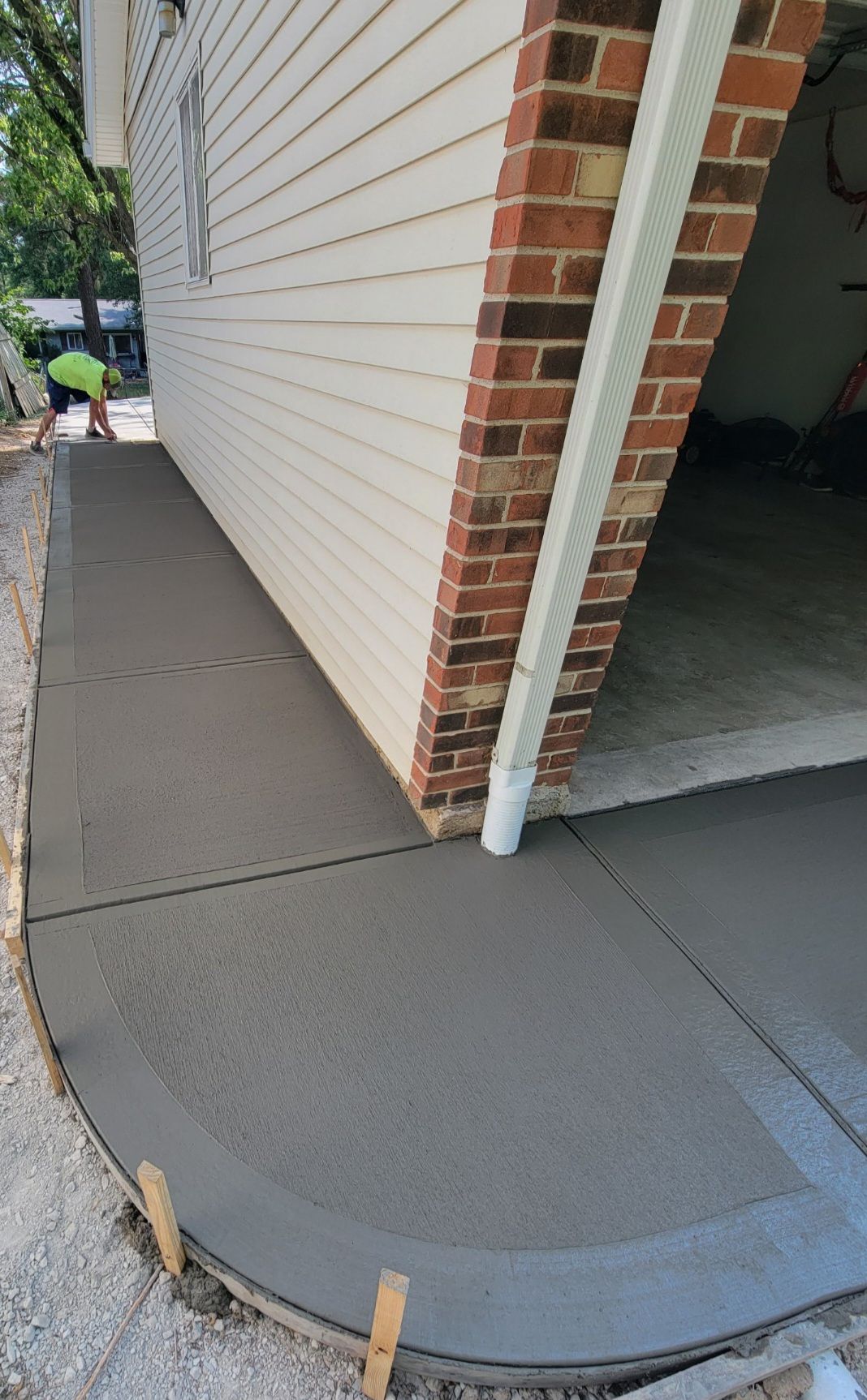 a concrete walkway is being built in front of a house .