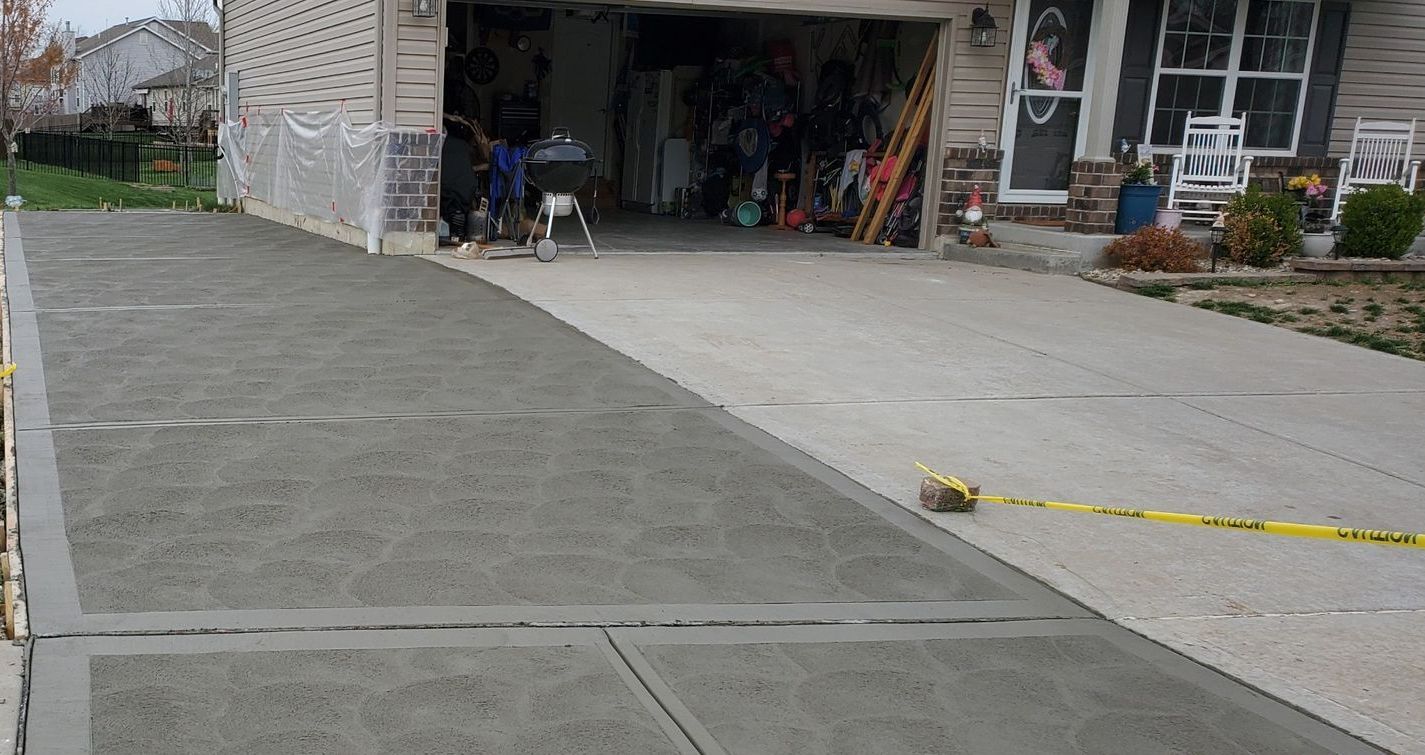 a concrete driveway is being built in front of a house .