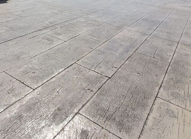 A close up of a concrete floor that looks like wood.