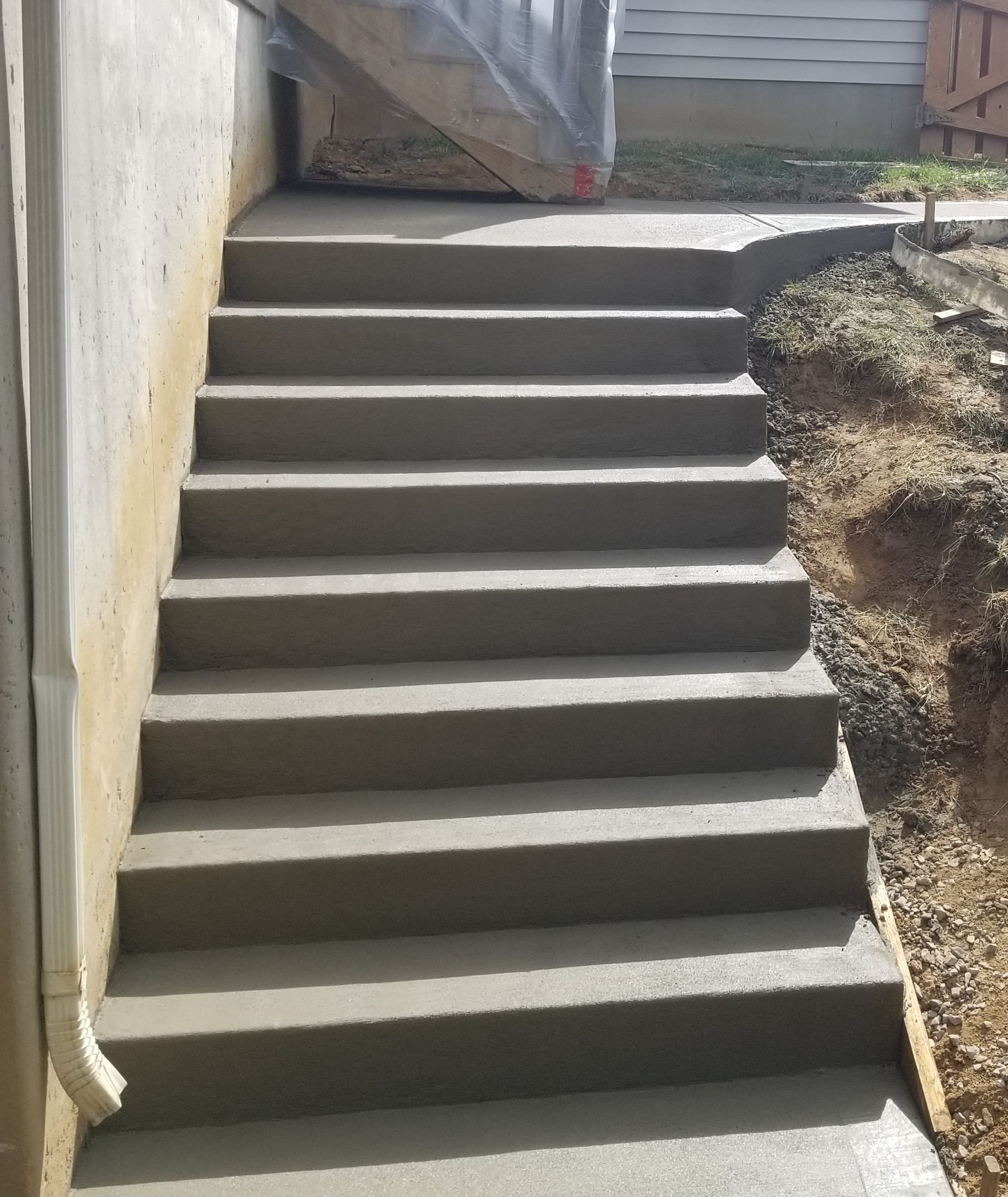a set of concrete stairs leading up to a house .