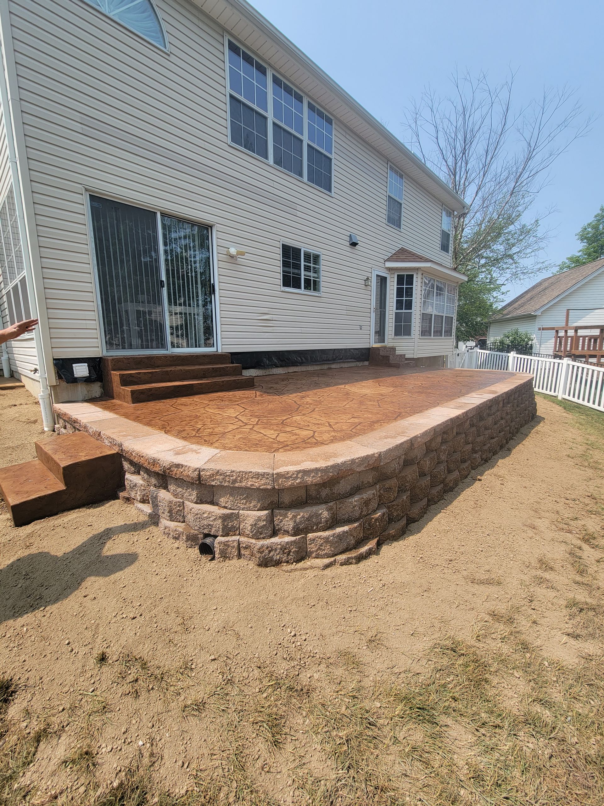 new stamped concrete patio with custom seating wall L &S Concrete STL