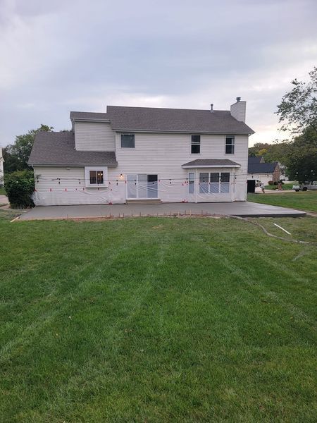 a large white house with a large lawn in front of it .