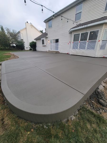 a concrete driveway is being built in front of a house .