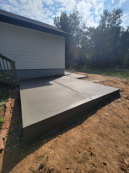 a concrete patio is being built in front of a house .