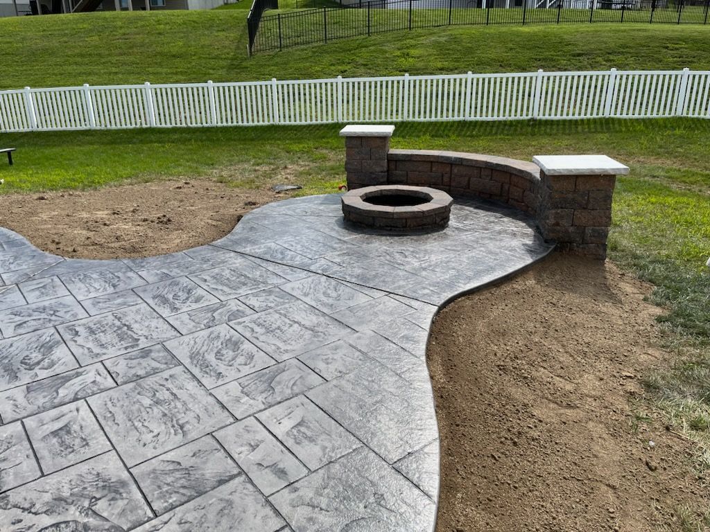 stamped concrete patio with fire pit and seating wall L & S