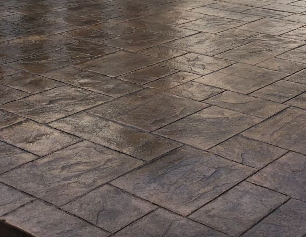 A close up of a brick floor with a diagonal pattern.