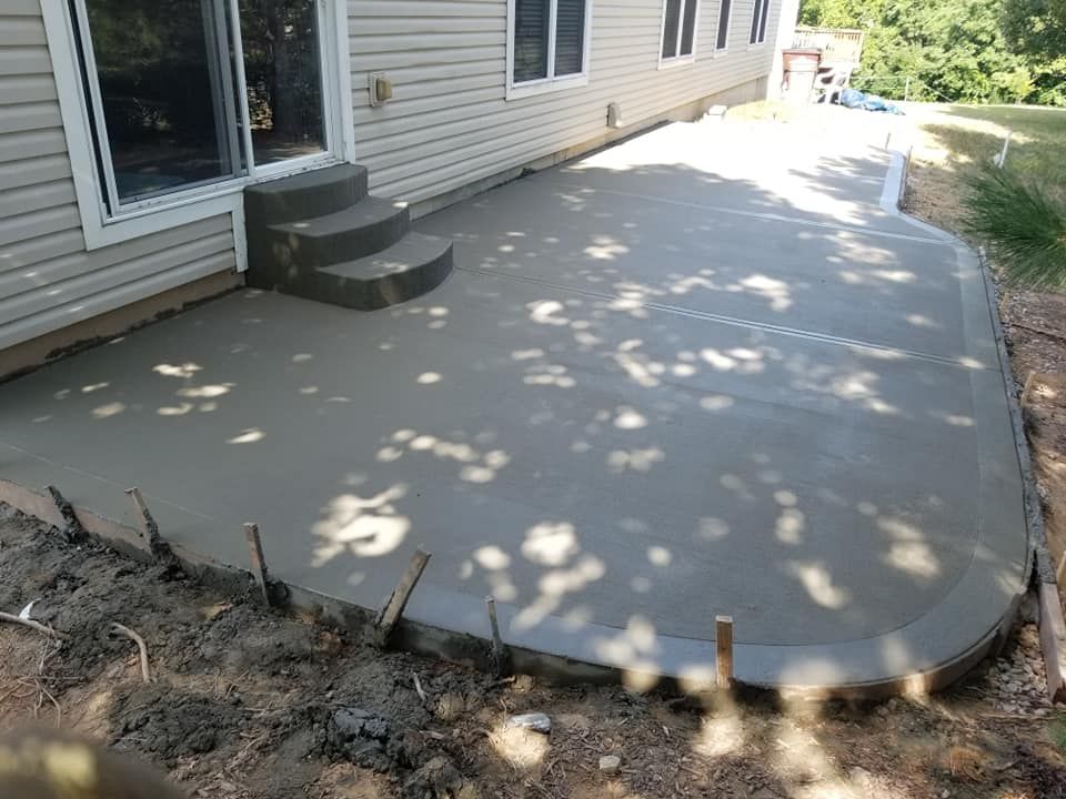 a concrete patio is being built in front of a house .