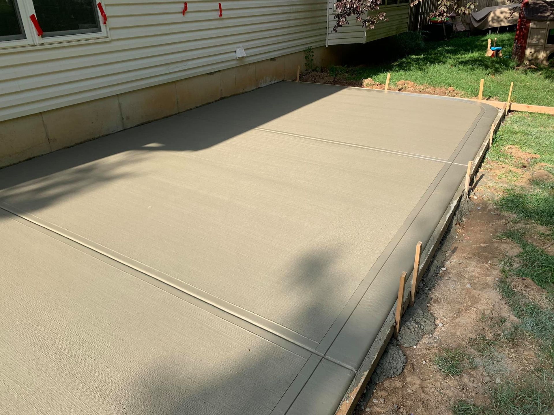 a concrete driveway is being built in front of a house .