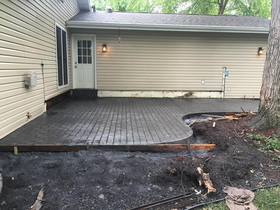 a patio is being built in front of a house .