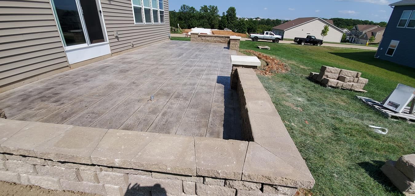 a patio is being built in the backyard of a house .