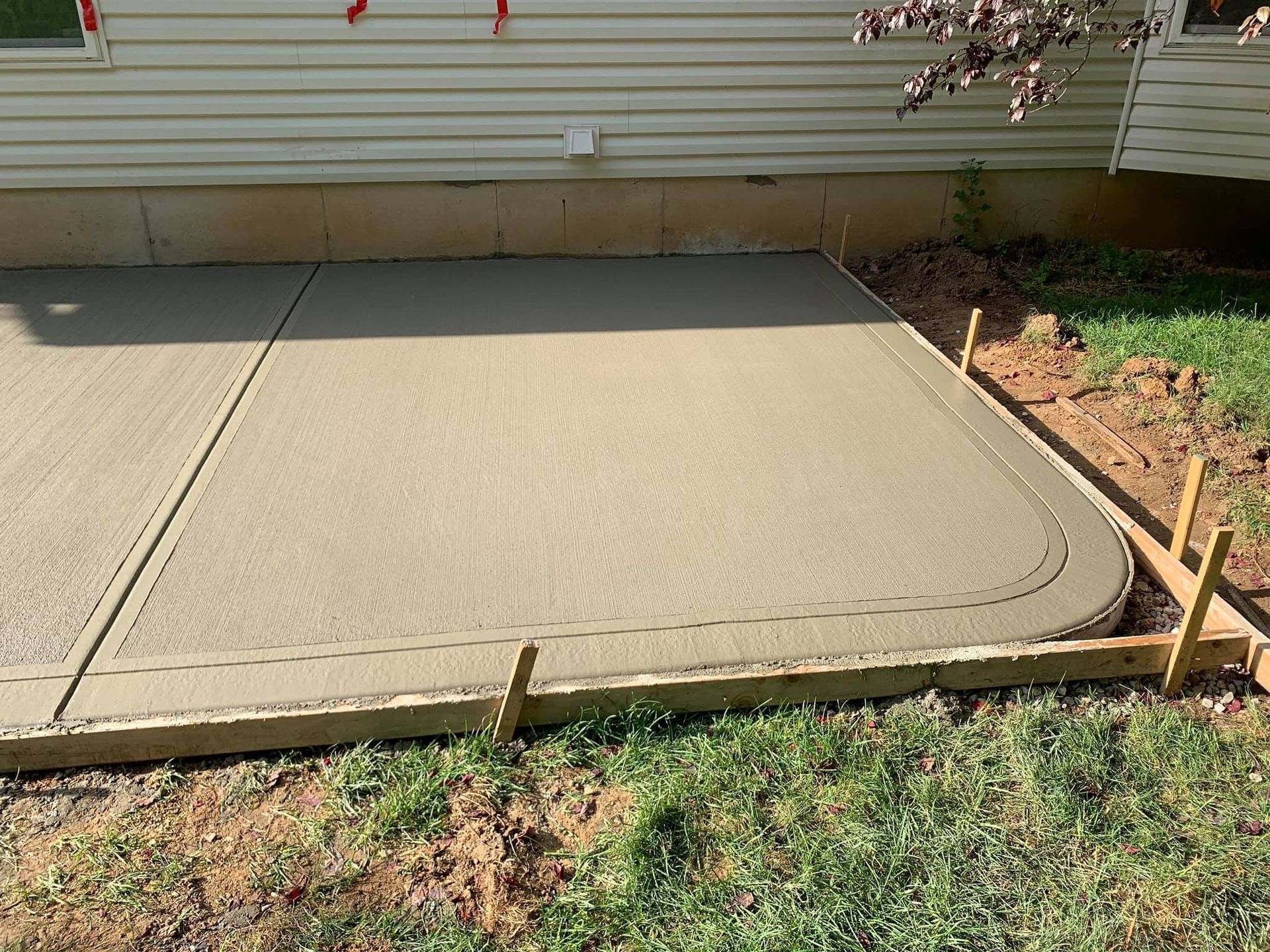 a concrete patio is being built in front of a house .