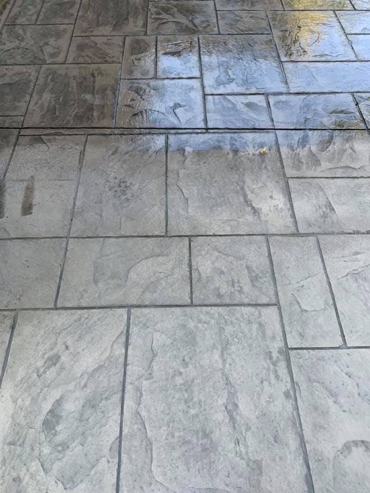 A close up of a concrete floor with a gray tile pattern.