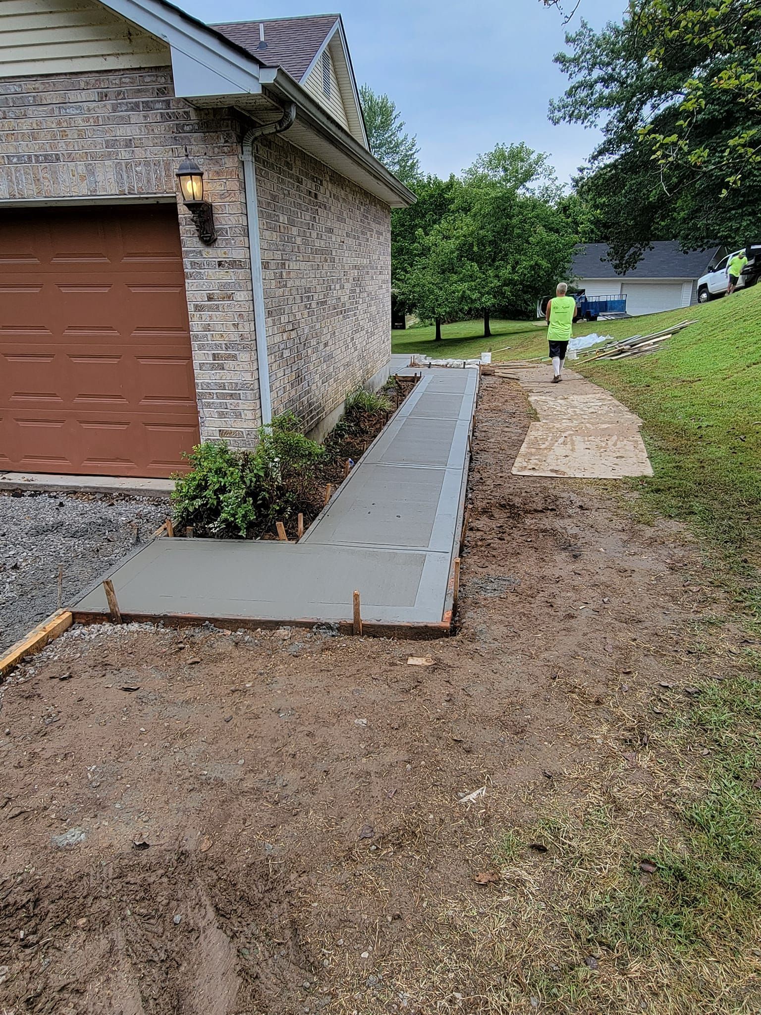 a concrete walkway is being built in front of a house .