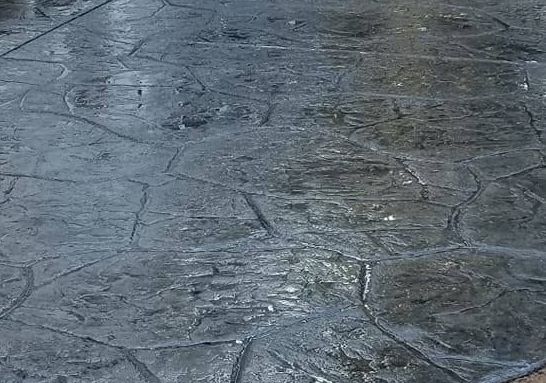 A close up of a concrete floor with a pattern on it.
